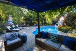 Private large outdoor area with in ground pool with covered pergola